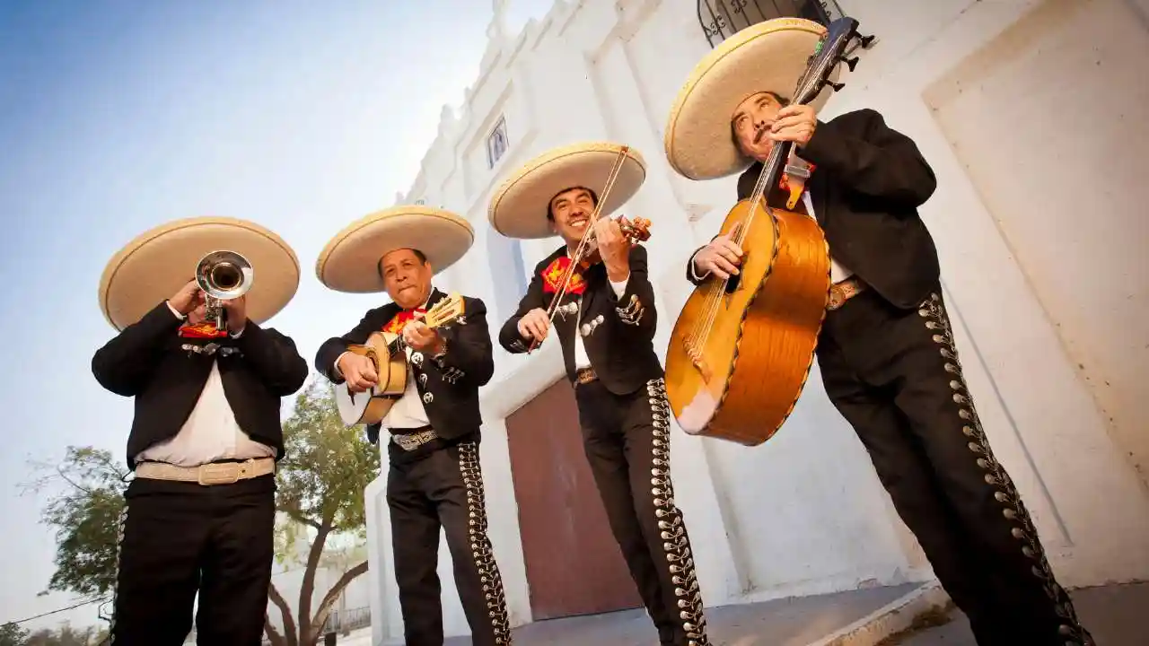4 musicians playing instruments 2 guitars, trumpet and violin
