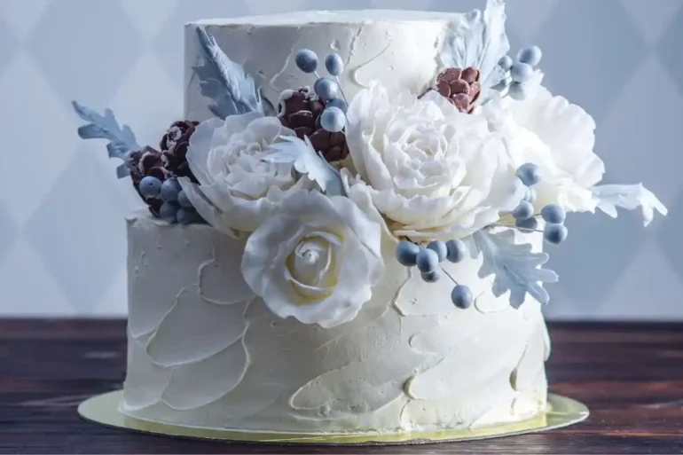 A beautiful wedding cake decorated with white and blue flowers