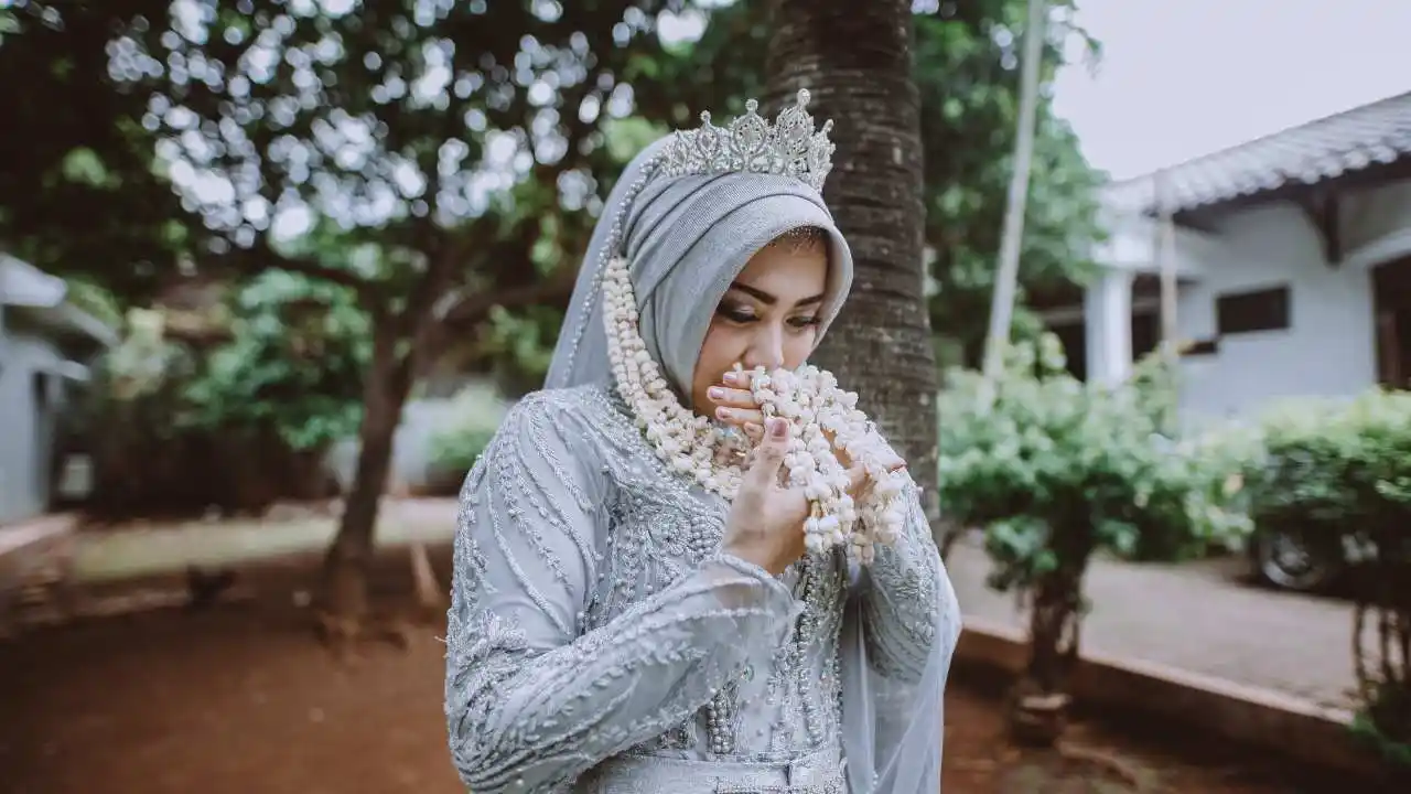 Muslim bride in beautiful gown with pearls and crown