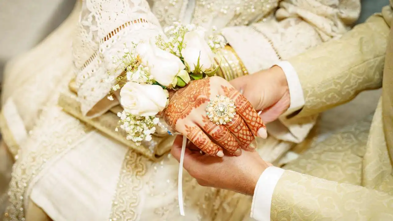 wedding photo, bride and groom holding hands, close up photo