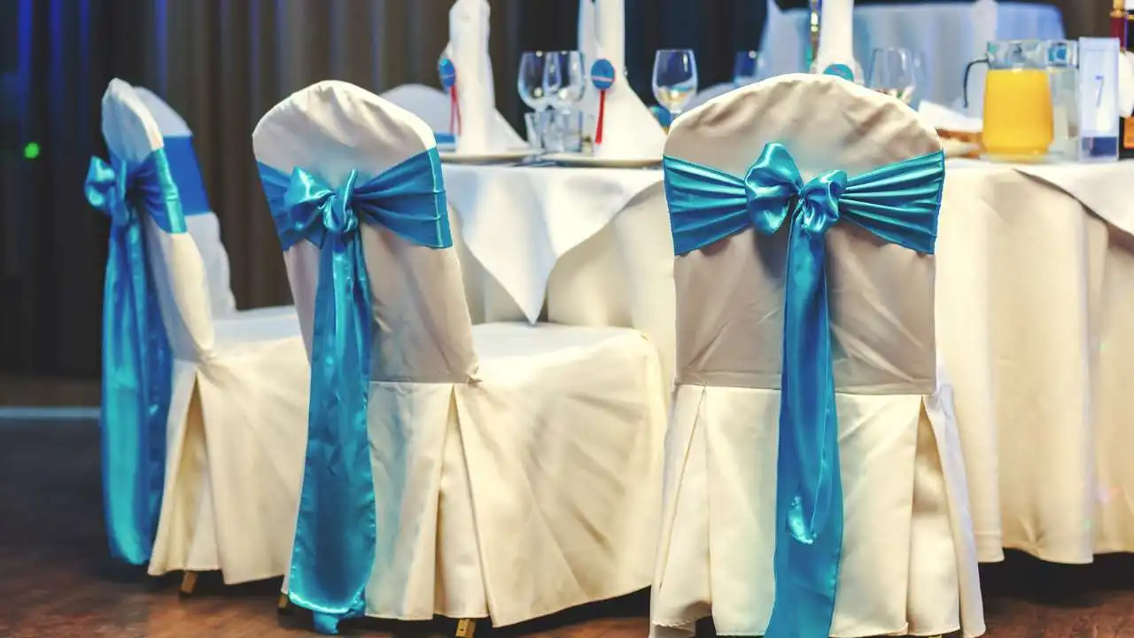 wedding table setting and chairs with ribbon